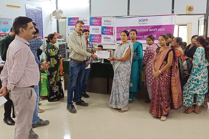 Adani Foundation community engagement â€” beneficiaries receiving certificates