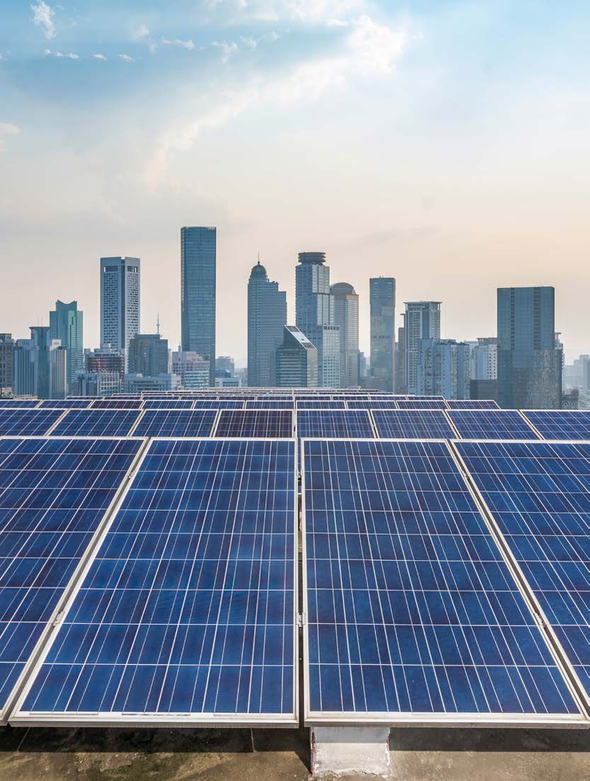Rooftop solar panels overlooking a city skyline
