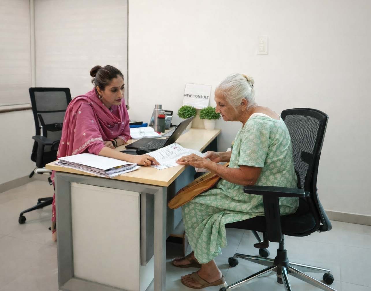 An Adani Electricity employee assisting a senior citizen customer